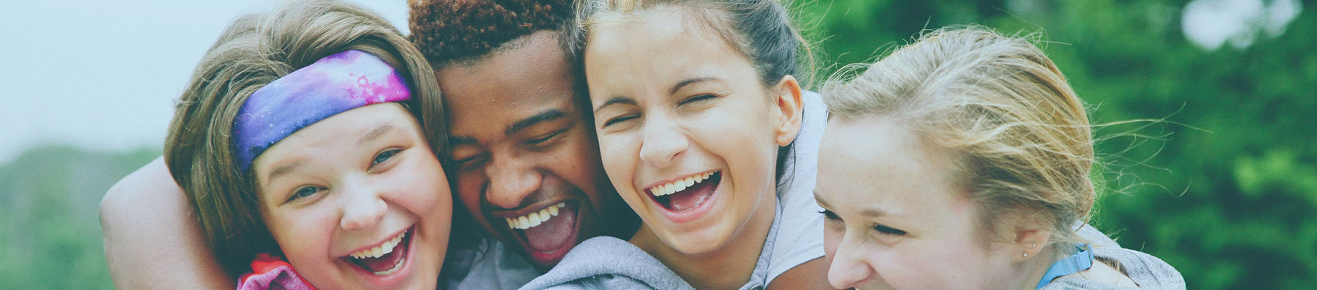 Four teens laughing.
